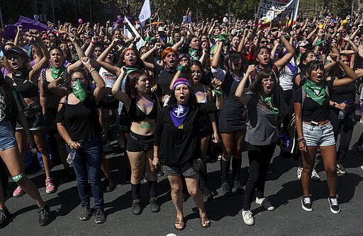 Women perform the feminist hymn &quot;A rapist in your path,&quot; during the International Women's Day strike in Santiago, Chile, Monday, March 9, 2020. (AP Photo/Esteban Felix)