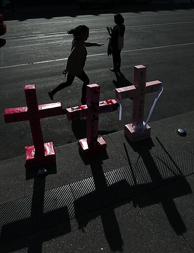 Women place crosses in Mexico City's main square the Zocalo, during the International Women's Day strike &quot;A day without women,&quot; Monday, March 9, 2020. Thousands of women across Mexico went on strike after an unprecedented number of girls and women took to the streets to protest against unbridled gender violence on International Women's Day. (AP Photo / Marco Ugarte)