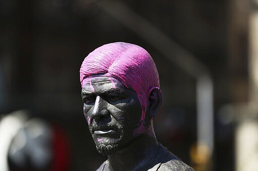 A statue of a man with its hair painted pink stands on a street during the International Women's Day strike &quot;A Day Without Women&quot; in Mexico City, Monday, March 9, 2020. Thousands of women across Mexico went on strike after an unprecedented number of girls and women hit the streets to protest rampant gender violence on International Women's Day. (AP Photo/Fernando Llano)