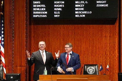 Louisiana House Speaker Clay Schexnayder, R-Gonzalez, left, and Senate President Page Cortez, R-Lafayette, react after Cortez broke Schexnayder's gavel for the opening of the 2020 general legislative session in Baton Rouge, La., Monday, March 9, 2020. (AP Photo/Gerald Herbert)