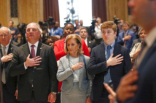 Louisiana Gov. John Bel Edwards holds his hand to his heart with his wife Donna Edwards and son John Miller Edwards, right, for the opening of the 2020 general legislative session in Baton Rouge, La., Monday, March 9, 2020. (AP Photo/Gerald Herbert)