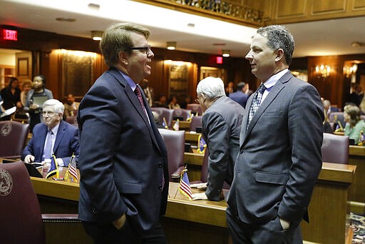 House Minority Leader Phil GiaQuinta, D-Fort Wayne, speaks with Rep. Todd Huston, R-Fishers, during the opening day of the session at the Statehouse, Monday, Jan. 6, 2020, in Indianapolis. (AP Photo/Darron Cummings)