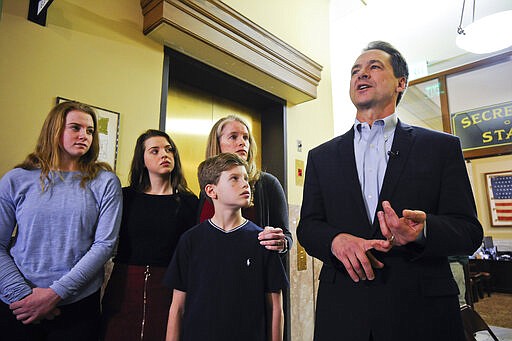 With his family by his side, Montana Gov. Steve Bullock speaks to the press after filing paperwork to run for U.S. Senate against incumbent Republican Sen. Steve Daines Monday, March 9, 2020 in Helena, Mont.  (Thom Bridge/Independent Record via AP)