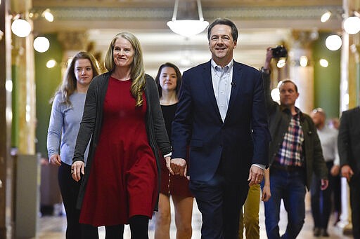 Montana Gov. Steve Bullock and his family arrive at the Montana Secretary of State office Monday, March 9, 2020 in Helena, Mont. Bullock filed paperwork to run for U.S. Senate against incumbent Sen. Steve Daines. (Thom Bridge/Independent Record via AP)