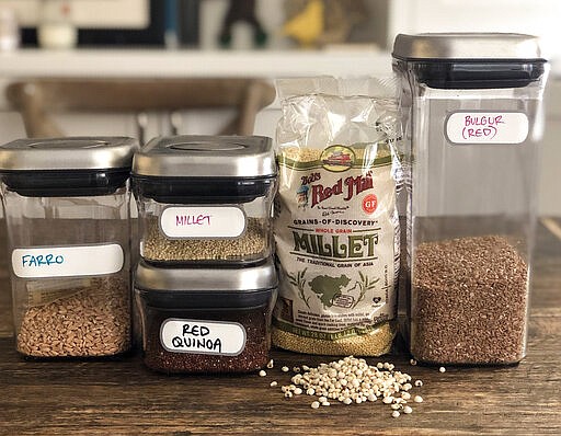 This Feb. 28, 2020 photo shows a sampling of whole grains on a kitchen counter in New York. Nutritionists have long touted the health benefits of whole grains. Especially today, when many people are cutting back on meat, whole grains can provide texture, flavor and often protein. (Katie Workman via AP)