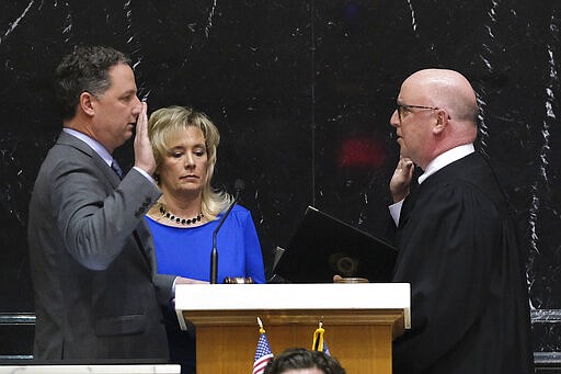 Todd Huston, R-Fishers, left, is sworn in as Speaker of the House by Indiana Supreme Court Justice Mark Massa in the House Chamber at the Statehouse in Indianapolis, Monday, March 9, 2020. Houston's wife Denise holds the bible to his right. (AP Photo/AJ Mast)