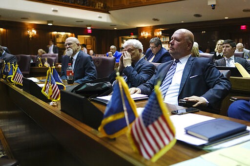 Speaker of the House Brian Bosma, R-Indianapolis, right, sits in the House Chamber before his planned resignation from the post at the Statehouse in Indianapolis, Monday, March 9, 2020.(AP Photo/AJ Mast)