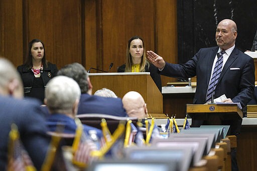 Former Speaker of the House Brian Bosma, R-Indianapolis, speaks from the podium on a resolution marking his stepping down from the post at the Statehouse in Indianapolis, Monday, March 9, 2020.(AP Photo/AJ Mast)