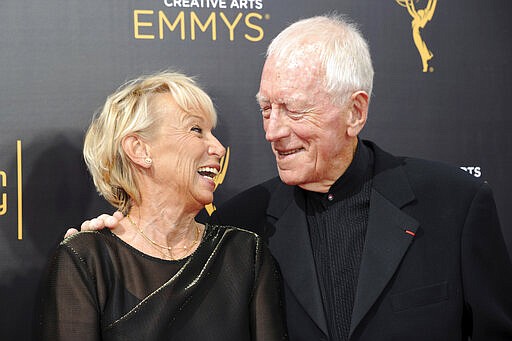 FILE - In this Saturday, Sept. 10, 2016 file photo, Max von Sydow and his wife Catherine Brelet, left, arrive at night one of the Creative Arts Emmy Awards at the Microsoft Theater in Los Angeles..Max von Sydow, the self-described &#147;shy boy&#148;-turned-actor who played the priest in the horror classic &#147;The Exorcist,&#148; has died, it was reported on Monday, March 9, 2020. He was 90. He was known to art house audiences through his work with Swedish director Ingmar Bergman. But it was his role as the devil-evicting priest in William Friedkin's controversial 1973 film &quot;The Exorcist&quot; that brought him to international attention. (Photo by Richard Shotwell/Invision/AP, File)