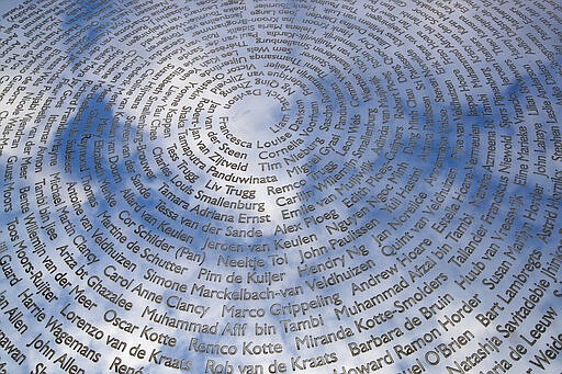 The sky is reflected in the national MH17 monument which carries the names of the victims of the downed Malaysia Airlines Flight 17 in Vijfhuizen, Netherlands, Friday, March 6, 2020. A missile fired from territory controlled by pro-Russian rebels in Ukraine in 2014, tore the MH17 passenger jet apart killing all 298 people on board. United by grief across oceans and continents, families who lost loved hope that next week's trial will finally deliver them something that has remained elusive ever since: The truth. (AP Photo/Peter Dejong)