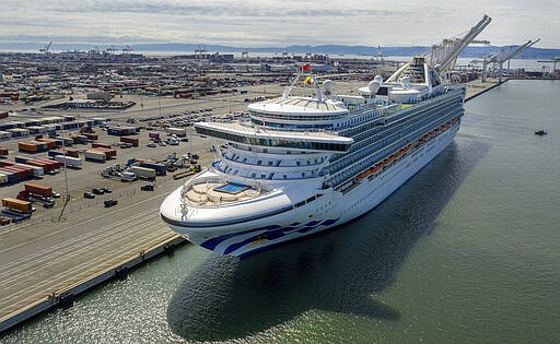 The Grand Princess docks at the Port of Oakland in Oakland, Calif., on Monday, March 9, 2020. The cruise ship, which had maintained a holding pattern off the coast for days, is carrying multiple people who tested positive for COVID-19, a disease caused by the new coronavirus. (AP Photo/Noah Berger)