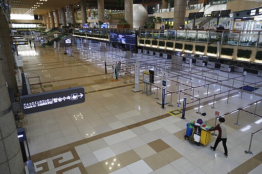 Check-in counters of Japanese airlines are empty at the Gimpo Airport in Seoul, South Korea, Monday, March 9, 2020. South Korea announced on Friday, March 6, it will end visa-free entry for Japanese citizens starting Monday in retaliation for a two-week quarantine imposed by Japan on all visitors from South Korea because of its surging viral outbreak. (AP Photo/Ahn Young-joon)