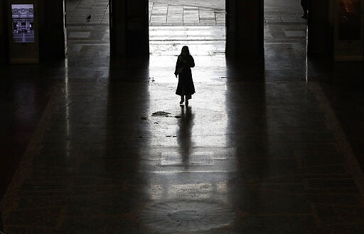 A lonely passenger leaves Milan main train station, Italy, Monday, March 9, 2020. Italy took a page from China's playbook Sunday, attempting to lock down 16 million people &#151; more than a quarter of its population &#151; for nearly a month to halt the relentless march of the new coronavirus across Europe. Italian Premier Giuseppe Conte signed a quarantine decree early Sunday for the country's prosperous north. Areas under lockdown include Milan, Italy's financial hub and the main city in Lombardy, and Venice, the main city in the neighboring Veneto region. (AP Photo/Antonio Calanni)