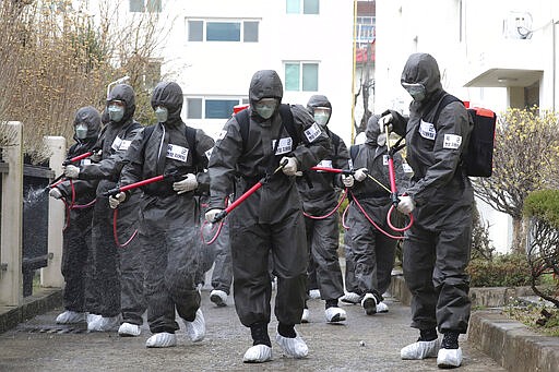 Army soldiers spray disinfectant as a precaution against a new coronavirus at an apartment building in Daegu, South Korea, Monday, March 9, 2020. The world&#146;s largest economies delivered more worrisome cues Monday as anxiety over the virus outbreak sent stock and oil prices plunging around the world. (Kim Ju-sung/Yonhap via AP)