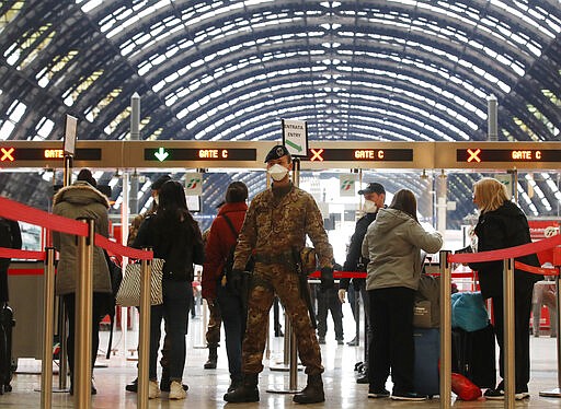 Police officers and soldiers check passengers leaving from Milan main train station, Italy, Monday, March 9, 2020. Italy took a page from China's playbook Sunday, attempting to lock down 16 million people &#151; more than a quarter of its population &#151; for nearly a month to halt the relentless march of the new coronavirus across Europe. Italian Premier Giuseppe Conte signed a quarantine decree early Sunday for the country's prosperous north. Areas under lockdown include Milan, Italy's financial hub and the main city in Lombardy, and Venice, the main city in the neighboring Veneto region. (AP Photo/Antonio Calanni)