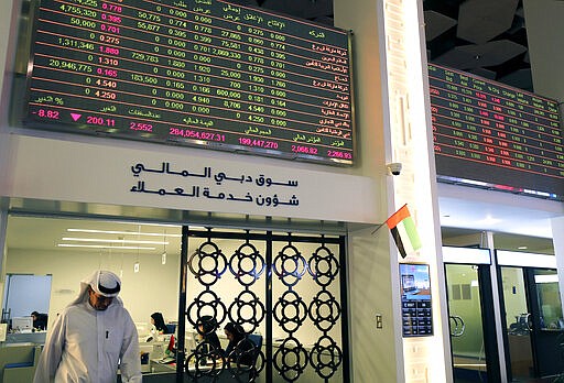 An Emirati trader leaves an office at the Dubai Financial Market in Dubai, United Arab Emirates, Monday, March 9, 2020. Saudi Arabia closed off air and sea travel to nine countries affected by the new coronavirus Monday as Mideast stock markets tumbled over fears about the widening outbreak's effect on the global economy. (AP Photo/Kamran Jebreili)