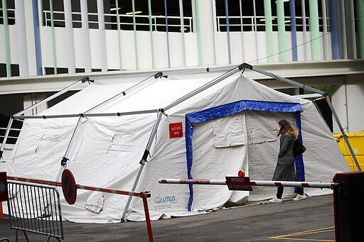 A tent used as a waiting room for people with covid-19 symptoms is set up in a courtyard of the Henri Mondor Hospital in Creteil, near Paris, Monday, March 9, 2020. The coronavirus is set to strike a severe blow to French growth in 2020, cutting several decimal points off a figure that may struggle to reach one percent, the finance minister said Monday. (AP Photo/Christophe Ena)