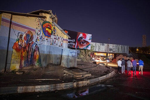 In this Jan. 12, 2020 photo, youth walk towards the tunnel under a railway track that was at the heart of last years' sit-in, the epicenter of the revolution, in Khartoum, Sudan. The young protesters who led Sudan's uprising against former President Omar al-Bashir, are now caught in the limbo of the country's fragile interim period. They say they've lost trust in the generals leading the country after a brutal crackdown on their sit-in last summer by security forces that killed dozens. Nearly a year after al-Bashir&#146;s ouster, the country faces a dire economic crisis, leaving many young people jobless. (AP Photo/Nariman El-Mofty)