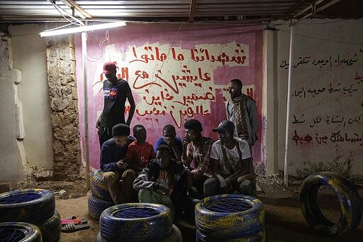 In this Jan. 10, 2020 photo, Sudanese activist and artist Youssef al-Sewahly, bottom left, gathers with his friends at the Revolutionary Martyrs Center, in Khartoum, Sudan. When al-Sewahly took to the streets in Sudan late in 2018, he and the other protesters had one goal: to remove the autocratic regime of Omar al-Bashir and replace it with a civilian-led government. They&#146;ve achieved the former, but the latter still hangs in the balance. (AP Photo/Nariman El-Mofty)