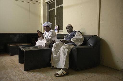 In this Jan. 11, 2020 photo, Sudanese fathers who lost their sons during last years' revolution, Farrah Abbas Farrah, left, and Abu Bakr, look at their son's photos and read documents, after a meeting for families who lost loved ones, at the Revolutionary Martyrs Center, in Khartoum, Sudan. Nearly a year after the ouster of former President Omar al-Bashir, the country faces a dire economic crisis, leaving many young people jobless. Generals remain the de-facto rulers of the country and have shown little willingness to hand over power to a civilian-led administration, one the demonstrators' key demands.&#160;(AP Photo/Nariman El-Mofty)