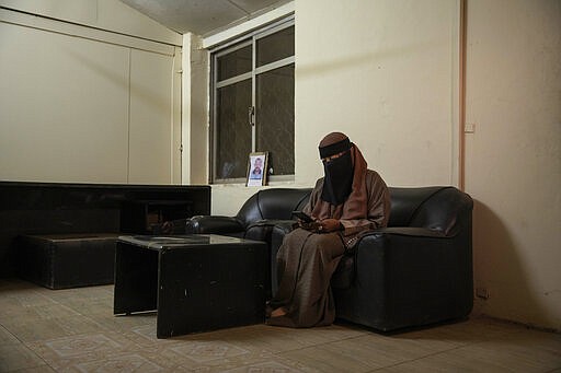 In this Jan. 11, 2020 photo, Sudanese Dr. Saadeya Seif, who lost her brother Awad Seif el-Din during last years' revolution looks at a photograph of him on her phone, after a meeting with families who lost loved ones, at the Revolutionary Martyrs Center, in Khartoum, Sudan. The young protesters who led the uprising against former President Omar al-Bashir, are now caught in the limbo of the country's fragile interim period. Generals remain the de-facto rulers of the country and have shown little willingness to hand over power to a civilian-led administration, one the demonstrators' key demands.&#160;(AP Photo/Nariman El-Mofty)