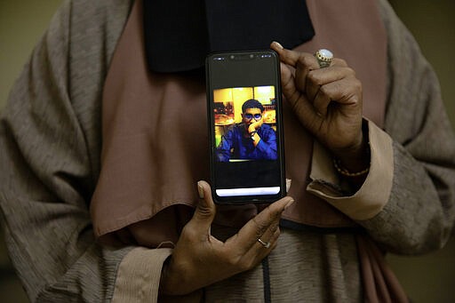 In this Jan. 11, 2020 photo, Sudanese Dr. Saadeya Seif, who lost her brother Awad Seif el-Din during last years' revolution shows a photograph of him on her phone, after a meeting with families who lost loved ones, at the Revolutionary Martyrs Center, in Khartoum, Sudan. The young protesters who led the uprising against former President Omar al-Bashir, are now caught in the limbo of the country's fragile interim period. Generals remain the de-facto rulers of the country and have shown little willingness to hand over power to a civilian-led administration, one the demonstrators' key demands.&#160;(AP Photo/Nariman El-Mofty)