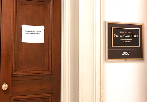 The Capitol Hill office door of Rep. Paul Gosar, R-Ariz., has a sign that reads, &quot;This office is closed until futher notice,&quot; shown Monday, March 9, 2020 on Capitol Hill in Washington.  On Sunday, Sen. Ted Cruz, R-Texas, and Gosar said they're isolating themselves after determining they had contact with a person at a Maryland political conference who got COVID-19.  (AP Photo/Padmananda Rama)