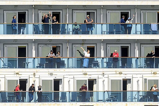 Passenger aboard the Grand Princess celebrate as they arrive in Oakland, Calif., on Monday, March 9, 2020. The cruise ship, which had maintained a holding pattern off the coast for days, is carrying multiple people who tested positive for COVID-19, a disease caused by the new coronavirus. (AP Photo/Noah Berger)