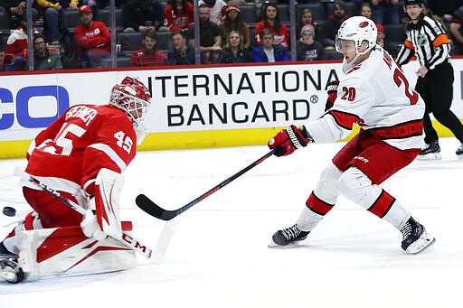 Carolina Hurricanes center Sebastian Aho (20) scores on Detroit Red Wings goaltender Jonathan Bernier (45) during the third period of an NHL hockey game Tuesday, March 10, 2020, in Detroit. (AP Photo/Duane Burleson)