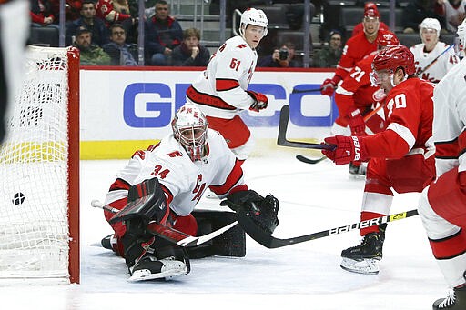 Detroit Red Wings center Christoffer Ehn (70) scores past Carolina Hurricanes goaltender Petr Mrazek (34) during the second period of an NHL hockey game Tuesday, March 10, 2020, in Detroit. (AP Photo/Duane Burleson)