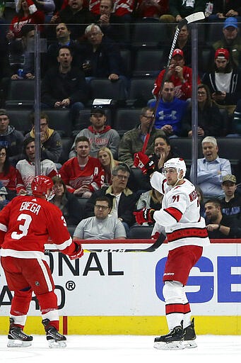 Carolina Hurricanes right wing Nino Niederreiter (21) celebrates his second-period goal in front of Detroit Red Wings defenseman Alex Biega (3) during an NHL hockey game Tuesday, March 10, 2020, in Detroit. (AP Photo/Duane Burleson)