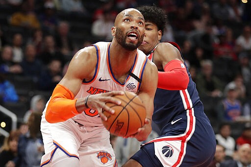 New York Knicks' Taj Gibson, front, moves past Washington Wizards' Rui Hachimura during the first half of an NBA basketball game Tuesday, March 10, 2020, in Washington. (AP Photo/Luis M. Alvarez)