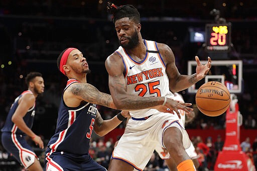 Washington Wizards' Shabazz Napier, front left, knocks the ball away from New York Knicks' Reggie Bullock (25) during the first half of an NBA basketball game Tuesday, March 10, 2020, in Washington. (AP Photo/Luis M. Alvarez)