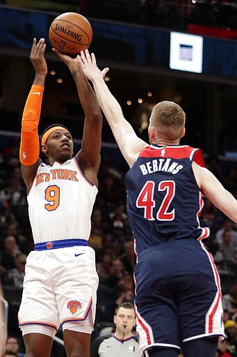 New York Knicks' RJ Barrett (9) shoots over \Washington Wizards' Davis Bertans (42) during the first half of an NBA basketball game Tuesday, March 10, 2020, in Washington. (AP Photo/Luis M. Alvarez)