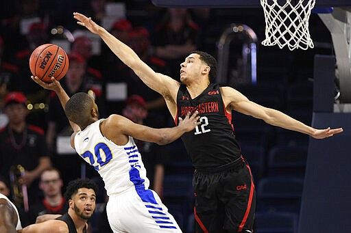 Hofstra guard Jalen Ray (20) goes to the basket against Northeastern guard Jordan Roland (12) during the first half of an NCAA college basketball game for the championship of the Colonial Athletic Association men's tournament Tuesday, March 10, 2020, in Washington. (AP Photo/Nick Wass)