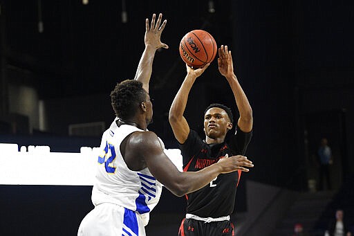 Northeastern guard Tyson Walker (2) shoots against Hofstra forward Isaac Kante (32) during the first half of an NCAA college basketball game for the championship of the Colonial Athletic Association conference tournament Tuesday, March 10, 2020, in Washington. (AP Photo/Nick Wass)