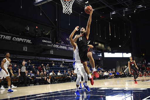 Northeastern guard Max Boursiquot (14) goes to the basket past Hofstra forward Kevin Schutte during the first half of an NCAA college basketball game for the championship of the Colonial Athletic Association men's tournament Tuesday, March 10, 2020, in Washington. (AP Photo/Nick Wass)