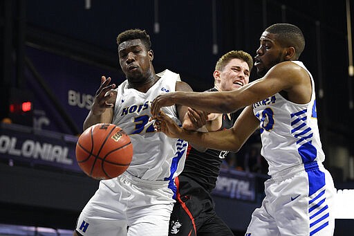 Hofstra forward Isaac Kante, left, and guard Jalen Ray, right, vie or the ball against Northeastern guard Bolden Brace, center, during the first half of an NCAA college basketball game for the championship of the Colonial Athletic Association men's tournament Tuesday, March 10, 2020, in Washington. (AP Photo/Nick Wass)