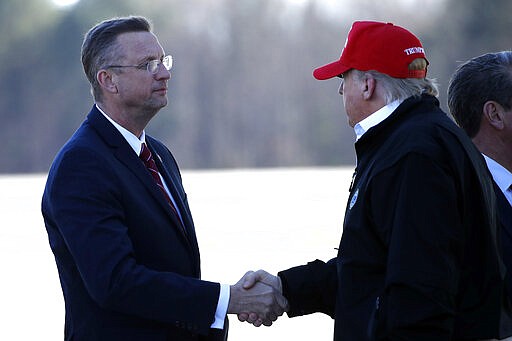 President Donald Trump greets Rep. Doug Collins, R-Ga., as he arrives on Air Force One Friday, March 6, 2020, at Dobbins Air Reserve Base in Marietta, Ga. (AP Photo/Alex Brandon)