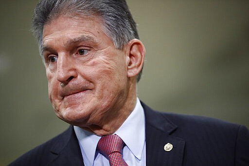 FILE - In this Feb. 5, 2020, file photo, Sen. Joe Manchin, D-W.Va., speaks with reporters after President Donald Trump was acquitted in an impeachment trial on charges of abuse of power and obstruction of Congress on Capitol Hill in Washington. A war of words between Trump and Manchin is heating up. The moderate Democrat took to cable news Monday, Feb. 10, to hurl barbs at the president after a weekend of back-and-forth that ignited when Trump criticized Manchin for voting to impeach him from office. (AP Photo/Patrick Semansky, File)