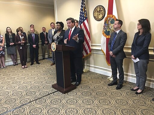 Florida Gov. Ron DeSantis meets with reporters on Monday, March 9, 2020, at the state Capitol in Tallahassee, Florida. DeSantis declared a state of emergency over a new strain of coronavirus to better mobilize resources and defended his proposal for teacher raises. (AP Photo/Bobby Caina Calvan)