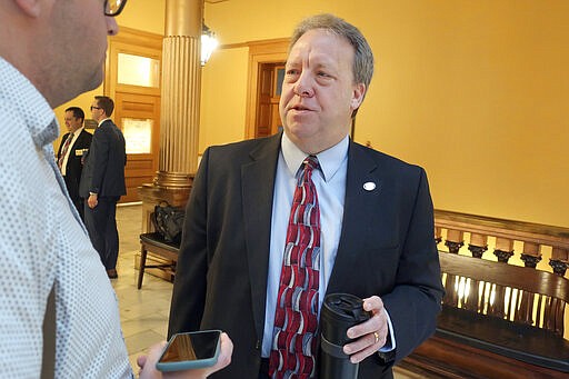 Kansas state Sen. Tom Holland, D-Baldwin City, talks to reporters after the Senate Commerce Committee's approval of a bill that would allow college athletes to hire agents and sign endorsement deals, Tuesday, March 10, 2020, at the Statehouse in Topeka, Kan. Holland's district includes part of Lawrence, Kan., home to the main University of Kansas campus. (AP Photo/John Hanna)