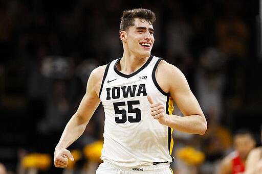 FILE - In this Feb. 20, 2020, file photo, Iowa center Luka Garza celebrates after making a basket during the first half of an NCAA college basketball game against Ohio State in Iowa City, Iowa. Garza was selected the Associated Press Big Ten Player of the Year Tuesday, March 10, 2020. (AP Photo/Charlie Neibergall, File)