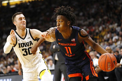 FILE - In this Feb. 2, 2020, file photo, Illinois guard Ayo Dosunmu drives to the basket past Iowa guard Connor McCaffery, left, during the first half of an NCAA college basketball game in Iowa City, Iowa. Dosunmu was selected to the Associated Press All-Big Ten team selected Tuesday, March 10, 2020.(AP Photo/Charlie Neibergall, File)