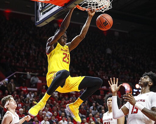 FILE - In this march 3, 2020, file photo, Maryland's Jalen Smith (25) dunks as Rutgers' Myles Johnson (15) watches during the first half of an NCAA college basketball game in Piscataway, N.J. Jalen Smith was selected to the Associated Press All-Big Ten team selected Tuesday, March 10, 2020. (AP Photo/John Minchillo, File)