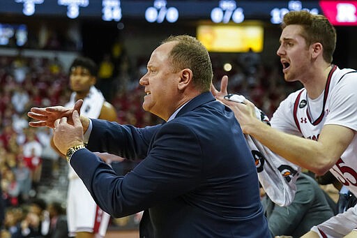 FILE - In this Feb. 23, 2020, file photo, Wisconsin head coach Greg Gard yells for a timeout during the first half of an NCAA college basketball game against Rutgers in Madison, Wis. At right is Nate Reuvers. Gard was selected the Associated Press  Big Ten Coach of the Year, Tuesday, March 10, 2020. AP Photo/Andy Manis, File)