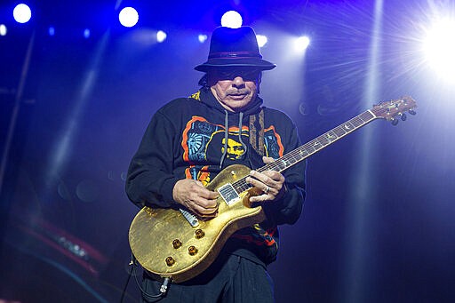 FILE - This May 26, 2019 file photo shows Carlos Santana of Santana performing at the BottleRock Napa Valley Music Festival  in Napa, Calif. Santana announced Tuesday, March 10, 2020 that he has canceled the European tour dates of his Miraculous 2020 World Tour. Refunds will be available through point of purchase. He is the latest musician to cancel concerts because of public health concerns and performance restrictions due to the growing coronavirus outbreak. The vast majority of people recover from the new virus. According to the World Health Organization, people with mild illness recover in about two weeks, while those with more severe illness may take three to six weeks to recover. (Photo by Amy Harris/Invision/AP, File)