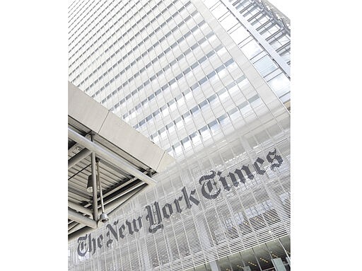 FILE - This June 22, 2019 file photo shows the exterior of the New York Times building in New York. Media companies are balancing the need to cover the coronavirus outbreak with the need to keep their employees safe. The New York Times told its employees this week that if they want to work remotely they can do so. For most people, the new coronavirus causes only mild or moderate symptoms, such as fever and cough. For some, especially older adults and people with existing health problems, it can cause more severe illness, including pneumonia. The vast majority of people recover from the new virus. According to the World Health Organization, people with mild illness recover in about two weeks, while those with more severe illness may take three to six weeks to recover. (AP Photo/Julio Cortez, File)