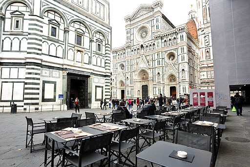 A cafe' is empty in Piazza del Duomo square, in Florence, Italy, Tuesday, March 10, 2020. Italy entered its first day under a nationwide lockdown after a government decree extended restrictions on movement from the hard-hit north to the rest of the country to prevent the spreading of coronavirus. (Jennifer Lorenzini/LaPresse via AP)