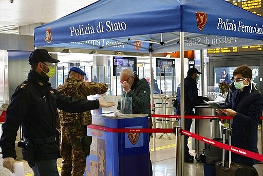 Border police check travelers documents at a check point inside Rome's Termini train station, Tuesday, March 10, 2020. In Italy the government extended a coronavirus containment order previously limited to the country&#146;s north to the rest of the country beginning Tuesday, with soldiers and police enforcing bans. (AP Photo/Andrew Medichini)